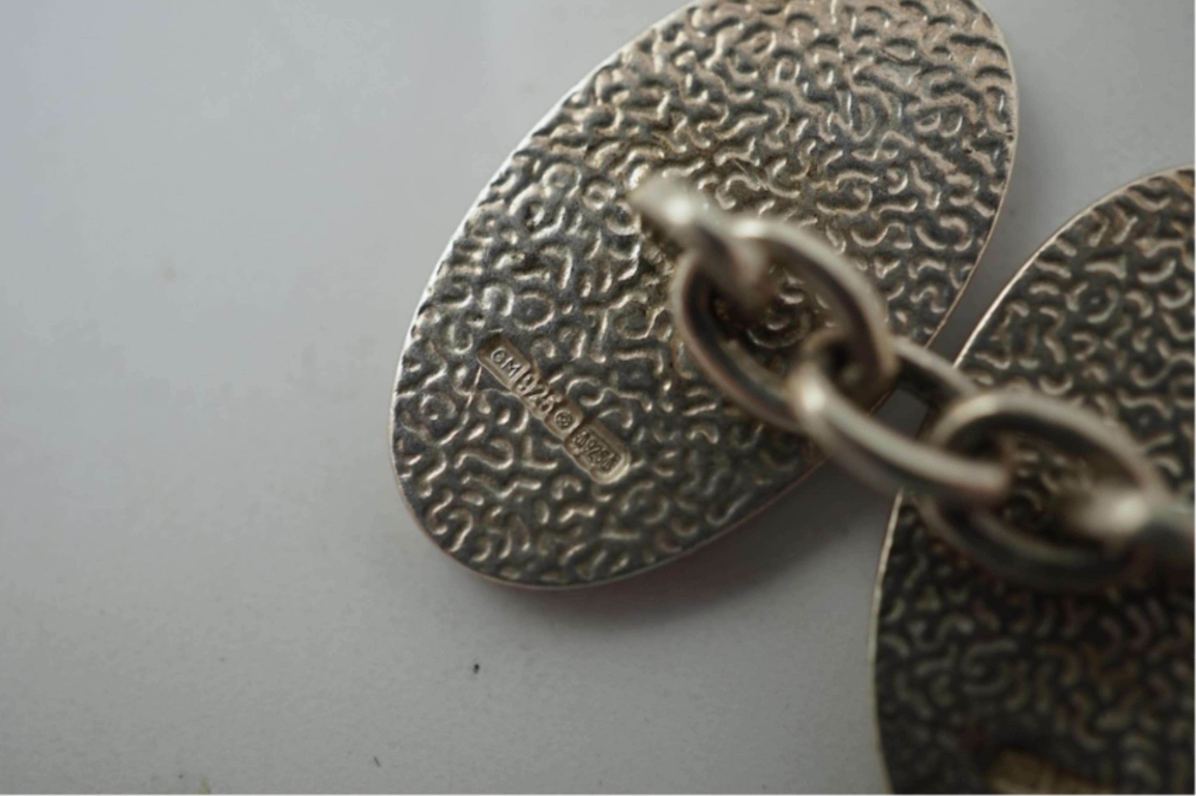 A modern pair of silver and polychrome enamel set oval cufflinks, 18mm.